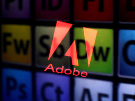FILE PHOTO: An Adobe logo and Adobe products are seen reflected on a monitor display and an iPad screen, in this picture illustration July 8, 2013. REUTERS/Dado Ruvic/Illustration/File Photo