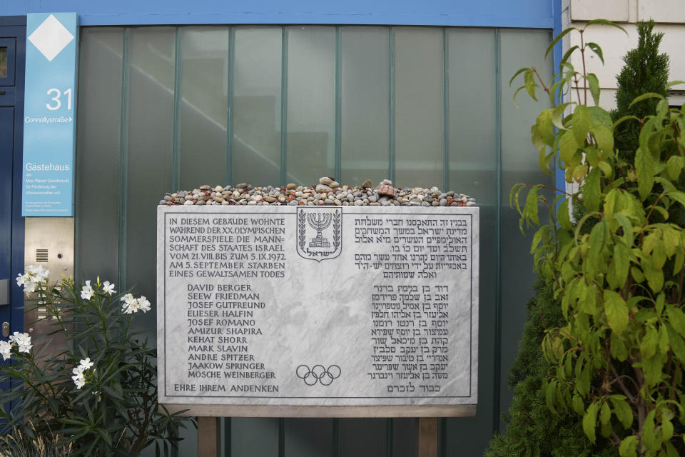 FILE - A memorial plaque for the eleven athletes from Israel and one German police officer were killed in a terrorist attack during the Olympic Games 1972, stands at the former accommodation of the Israeli team in the Olympic village in Munich, Germany, Saturday, Aug. 27, 2022. Shaul Ladany survived a Nazi concentration camp and narrowly escaped the massacre of the Israeli athletes at the 1972 Olympic Games in Munich. Both attempts to murder him happened on German soil in the last century. Many decades later, the 86-year-year old Jew has returned to visit the two places where he narrowly escaped death. (AP Photo/Matthias Schrader, File)