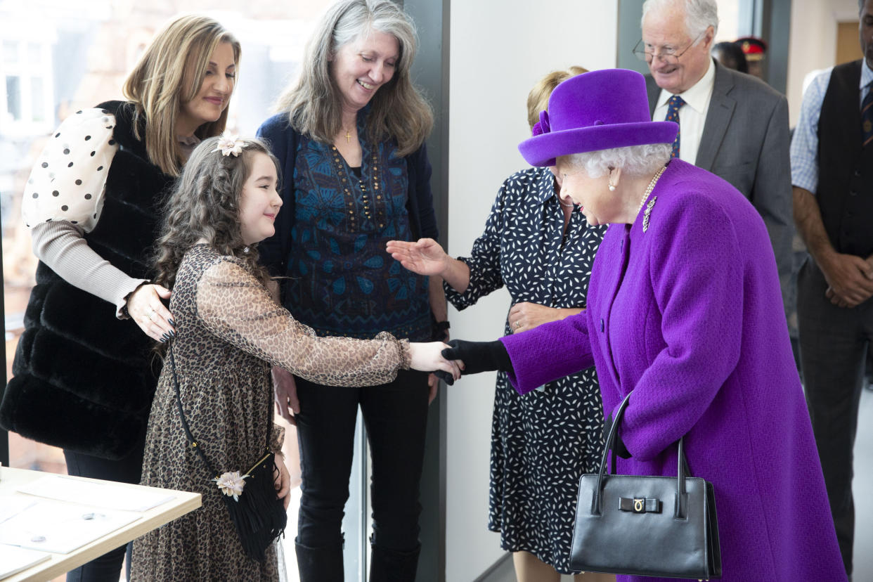 RETRANSMITTING WITH UPDATED CAPTION INFORMATION Queen Elizabeth II meeting eight year old Lily Conlan, a cochlear implant patient, as she officially opens the new premises of the Royal National ENT and Eastman Dental Hospitals in London.