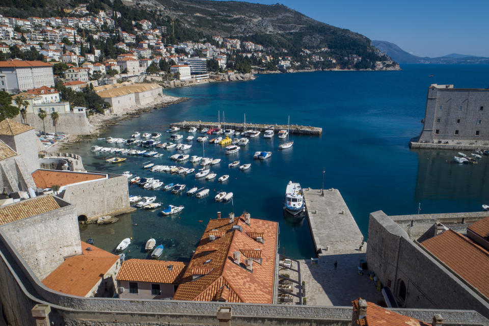 This Tuesday, March 17, 2020 aerial photo shows the old town harbor and the Lazarettos, called Lazareti in Croatian, of Dubrovnik, in Dubrovnik, Croatia. Just outside the majestic walls of Croatia’s medieval citadel city of Dubrovnik lies a cluster of small stone houses known as the Lazzarettos of Dubrovnik, today an art and clubbing hub and a tourist attraction. But the coronavirus spreads worldwide, some are recalling their original purpose centuries ago as an isolation zone for arrivals who might be carrying infectious diseases. Dubrovnik, on the Adriatic coast, was the first city in Europe to set up a quarantine system, in 1377, as protection from leprosy. The Lazzarettos complex was built in the 17th century when authorities decided to set up the quarantine area closer to the harbor. (AP Photo/Darko Bandic)