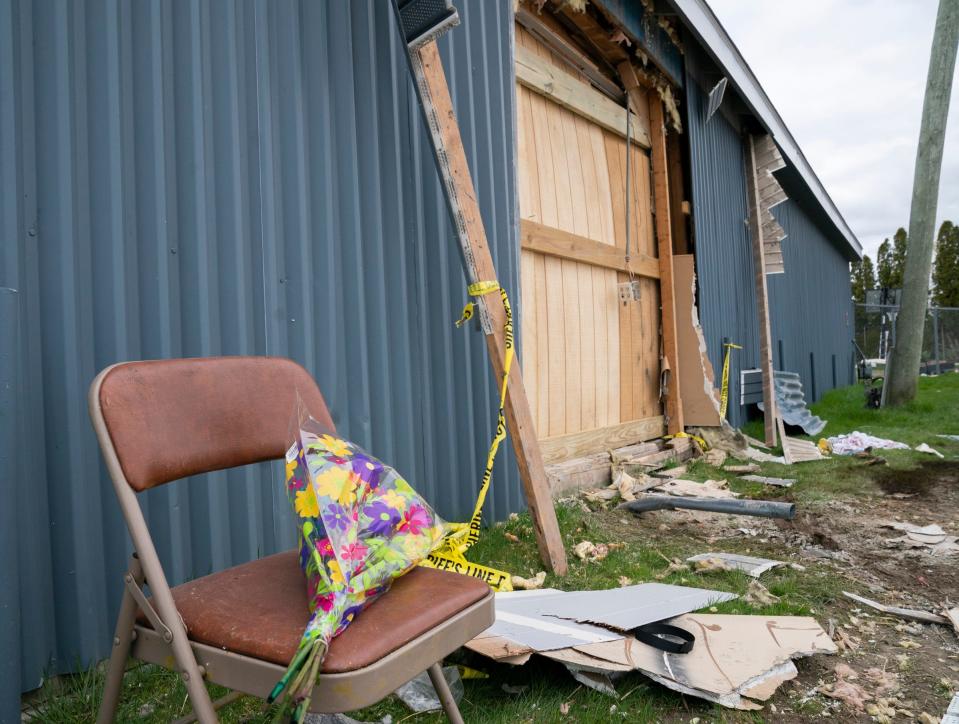 Flowers were left at the scene Sunday where a driver smashed through a wall at the Swan Boat Club during a child’s birthday party in Newport.