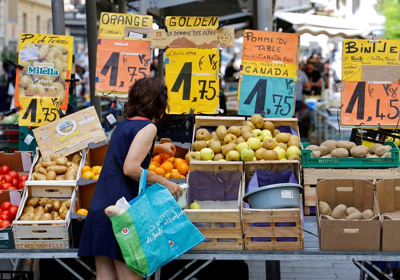 FILE PHOTO: Price tags are seen as a woman shops at a local market in Nice