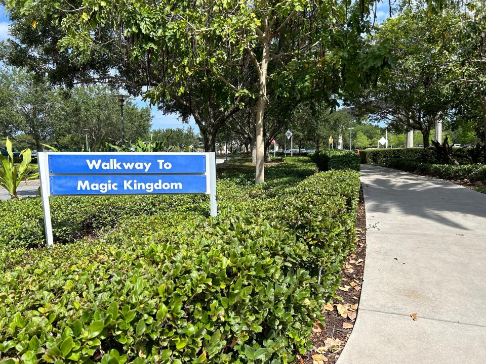 walkway to magic kingdom sign in bush