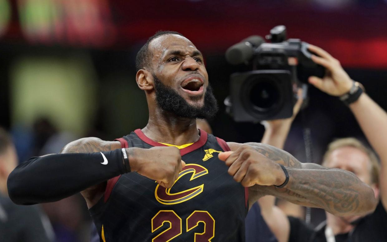 LeBron James celebrates after scoring the game-winning shot - AP