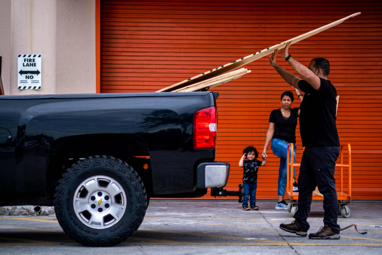 A man loads wood in his vehicle outside a Home Depot store in preparation for the arrival of Hurricane Ian in Tampa, Fla., on Sept. 27, 2022. (Ricardo Arduengo / AFP - Getty Images)