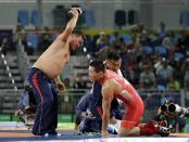 <p>Coaches for Mongolia’s Mandakhnaran Ganzori, at right, strip in protest after a loss to Uzbekistan’s Ikhtiyor Navruzov during the men’s 65-kg freestyle bronze medal wrestling match at the 2016 Summer Olympics in Rio de Janeiro, Brazil, Saturday, Aug. 20, 2016. (AP) </p>