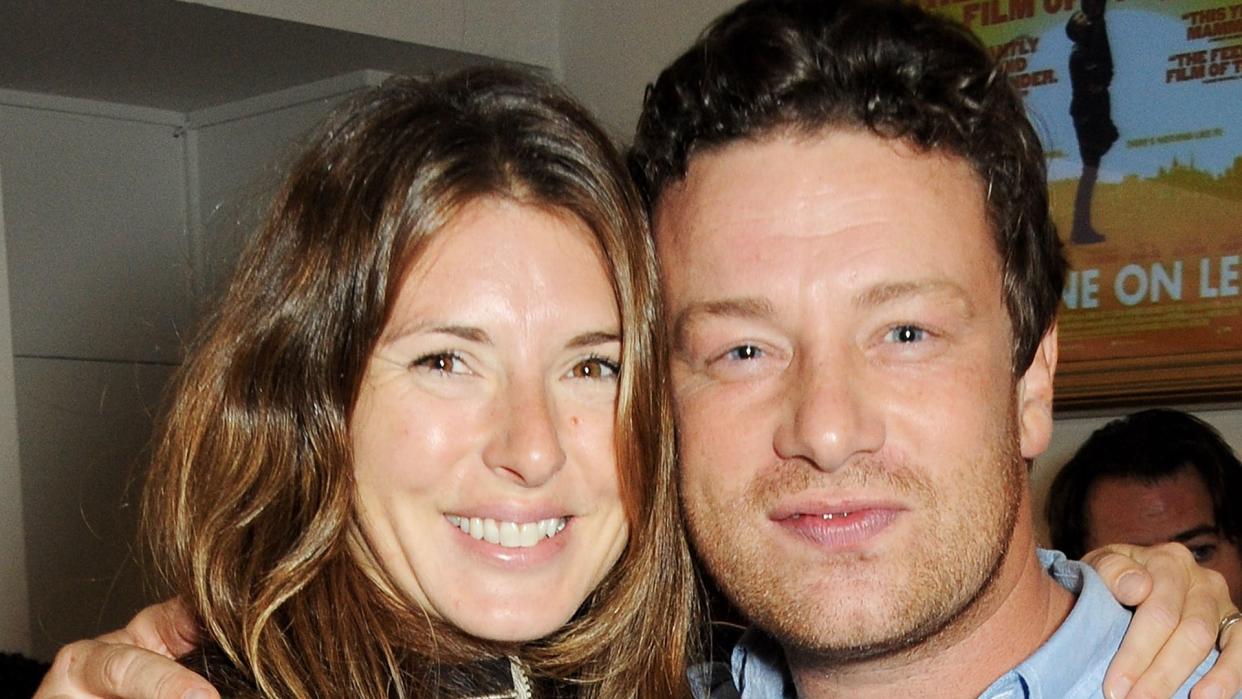 Jools Oliver and Jamie Oliver embracing