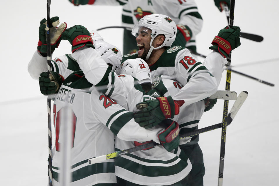 Minnesota Wild left wing Jordan Greenway (18) celebrates with teammates on a goal by left wing Kevin Fiala (22), of Switzerland, after scoring against the Anaheim Ducks during the overtime period of an NHL hockey game in Anaheim, Calif., Sunday, March 8, 2020. The Wild won 5-4 in overtime. (AP Photo/Alex Gallardo)