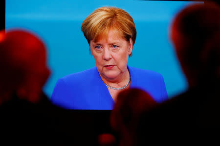 Journalists watch a TV debate between German Chancellor Angela Merkel of the Christian Democratic Union (CDU) and her challenger Germany's Social Democratic Party SPD candidate for chancellor Martin Schulz in Berlin, Germany, September 3, 2017. REUTERS/Fabrizio Bensch