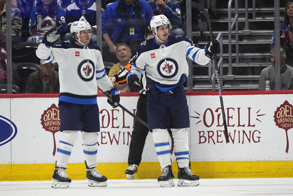 Winnipeg Jets center Sean Monahan, right, celebrates with center Tyler Toffoli after scoring in the first period of an NHL hockey game against the Colorado Avalanche, Saturday, April 13, 2024, in Denver. (AP Photo/David Zalubowski)