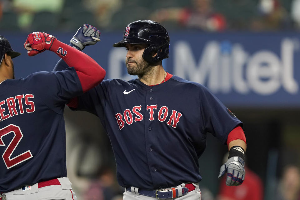 Boston Red Sox designated hitter J.D. Martinez, right, celebrates his solo home run with teammate Xander Bogaerts (2) during the first inning of a baseball game against the Texas Rangers in Arlington, Texas, Saturday, May 14, 2022. (AP Photo/LM Otero)