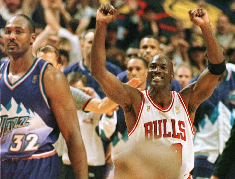 Michael Jordan celebrates as Karl Malone looks on during the Bulls' win in Game 6 of the 1997 NBA Finals.