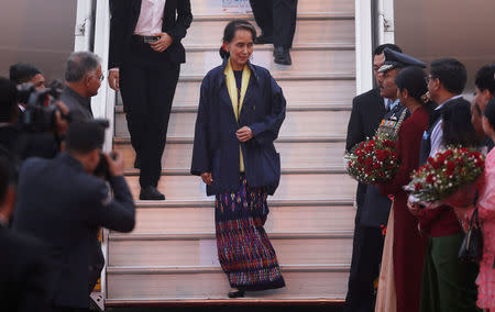 Myanmar's State Counsellor Aung San Suu Kyi disembarks from an airplane upon her arrival at Air Force Station Palam in New Delhi, India, January 24, 2018. REUTERS/Adnan Abidi