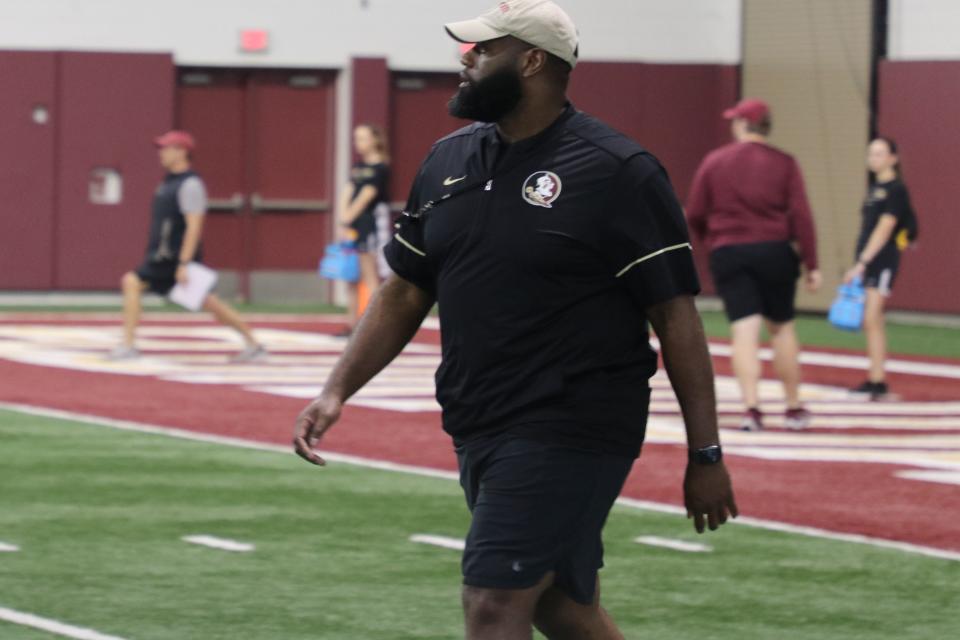 FSU offensive coordinator/offensive line coach Alex Atkins watches team stretch during the Seminoles' third spring football practice on Wednesday, March 9, 2022.