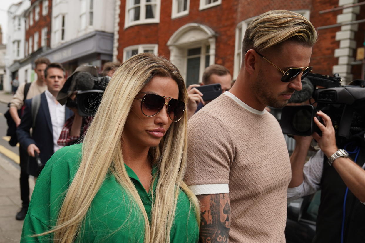 Katie Price leaves Lewes Crown Court with fiance Carl Woods after being sentenced for breaching the restraining order. (Getty Images)