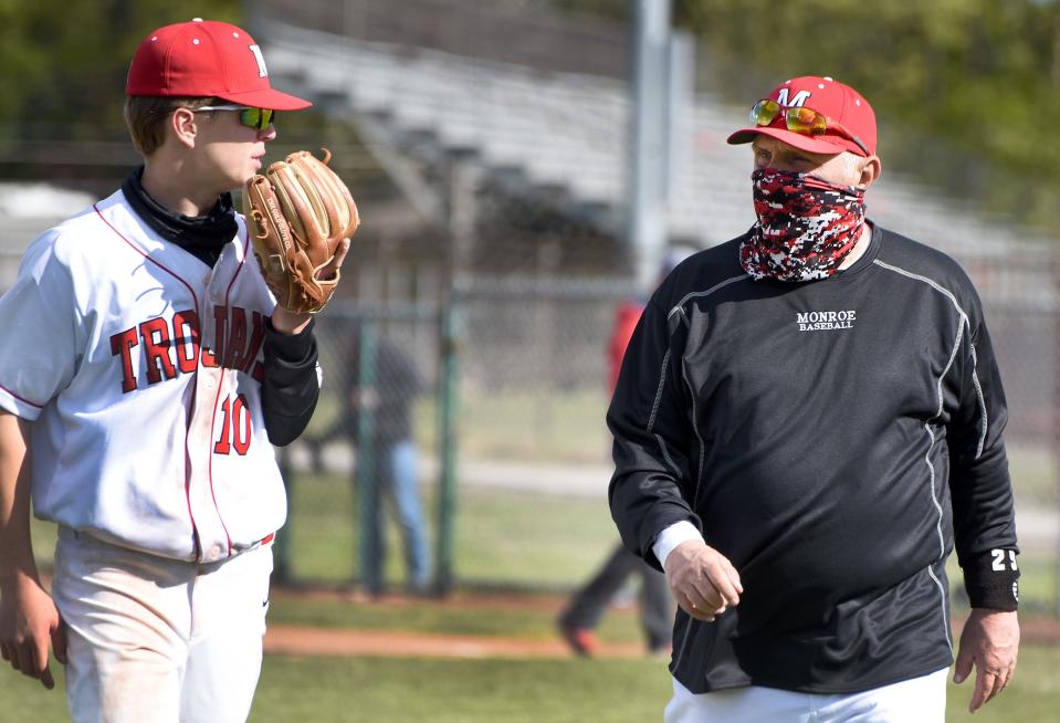 Bubba Bezeau (right) talks to Ryan Sieler during a game in 2021. Bezeau resigned as Monroe's baseball coach Sunday.