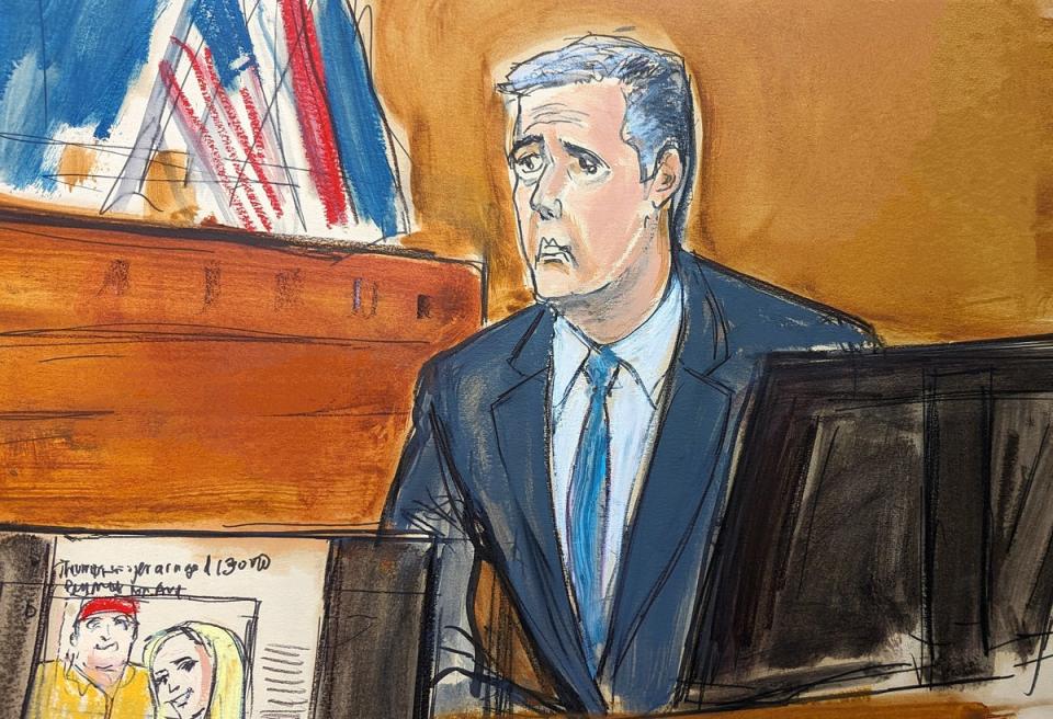 Michael Cohen testifies as a Wall Street Journal article is displayed on a screen in Manhattan criminal court on Tuesday 14 May 2024 (AP)