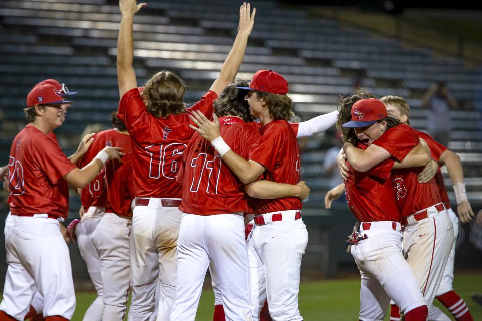 Members of Scottsdale Christian Academy celebrate a win over Benson High School following a 2A state championship game held at Tempe Diablo Stadium on May 14, 2022. Monica D. Spencer/The Republic 9709308002