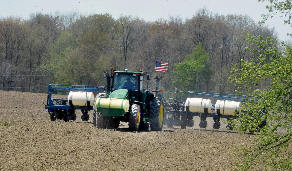 When the ground is dry farmers are busy preparing and planting spring crops. A farmer is planting soy beans near Smithville.
