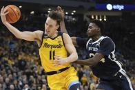 Butler's Ali Ali fouls Marquette's Tyler Kolek during the first half of an NCAA college basketball game Saturday, Feb. 4, 2023, in Milwaukee. (AP Photo/Morry Gash)