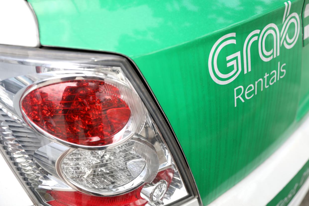 The Grab Rental logo is displayed on the trunk of a car in Singapore, on Thursday, April 26, 2018. (Paul Miller/Bloomberg)