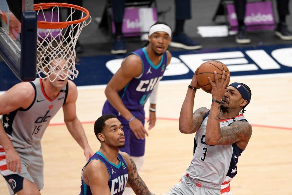 Washington Wizards guard Bradley Beal (3) goes to the basket against Charlotte’s P.J. Washington, center, during the first half of Washington’s 115-110 win Sunday.