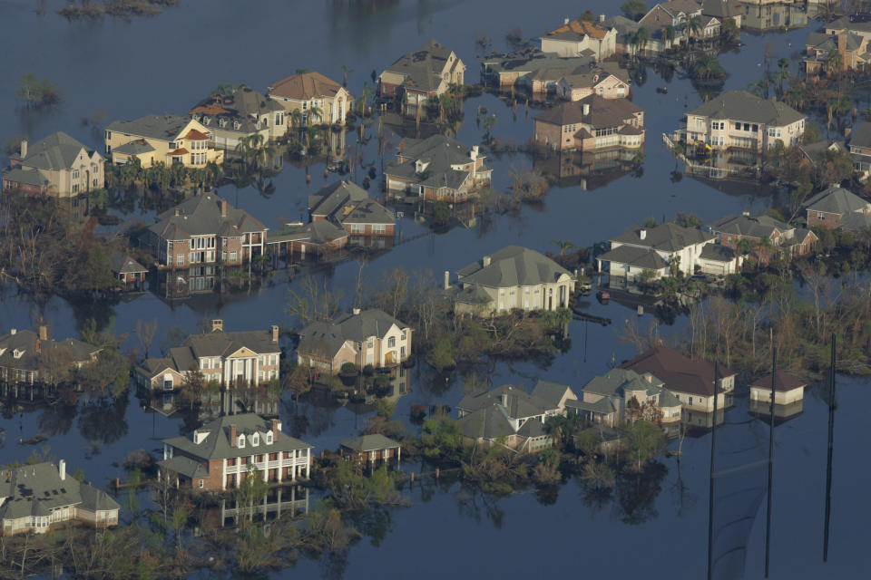 Two weeks after Hurricane Katrina hit New Orleans, neighborhoods were still flooded with oil and water.&nbsp;People who are&nbsp;exposed to disaster zones for longer and receive less support afterward are&nbsp;more vulnerable to&nbsp;mental health issues. (Photo: Carlos Barria / Reuters)