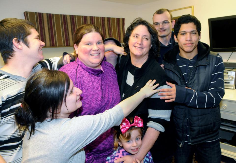 Tammy Josyln is surrounded by people who love her during the community dinner at Wamesit Place as they gather around her for a photo.