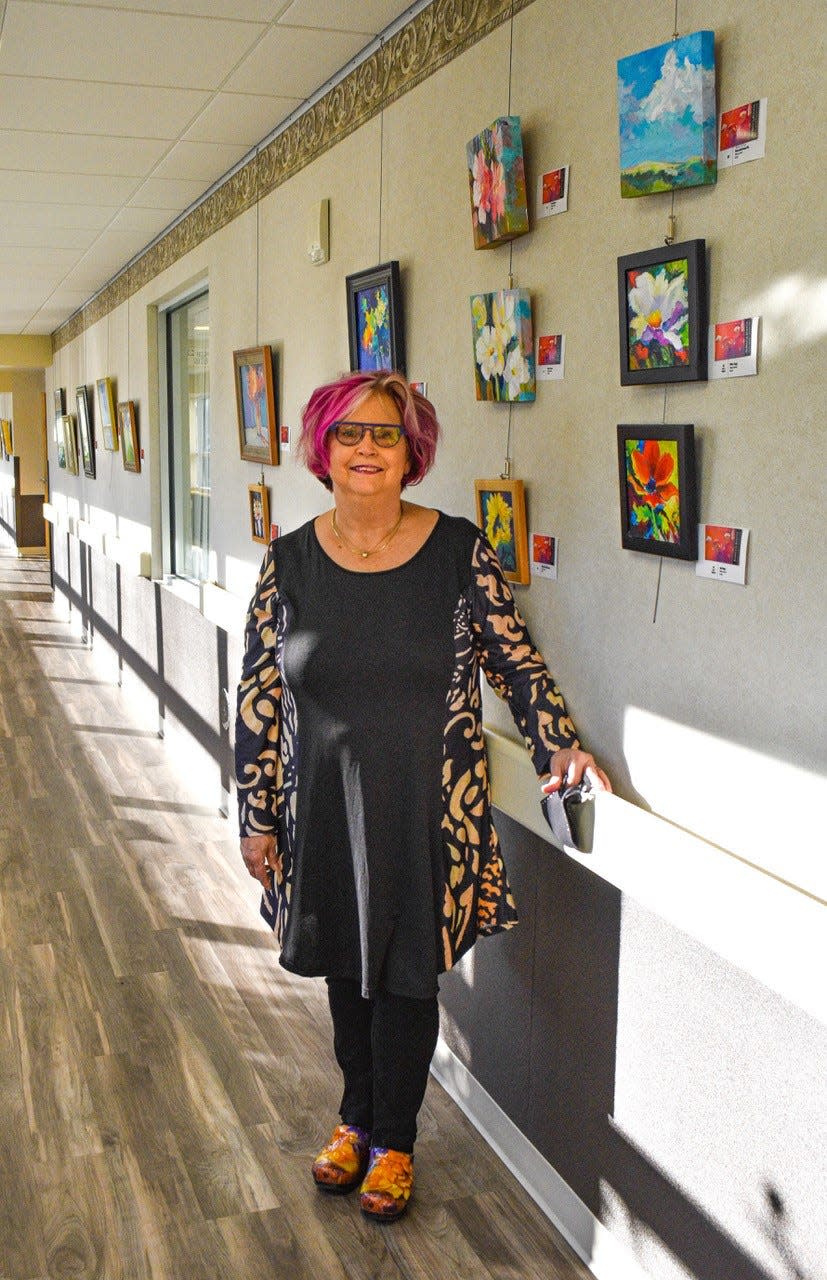 Rebecca Booth currently has 26 paintings on display at Magruder Hospital, where she hopes her work will “bring a smile to a somber situation.”