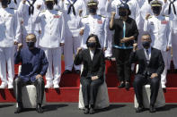 Taiwan's President Tsai Ing-wen, center, cheers with officers during the commissioning ceremony of the the domestically made Ta Jiang warship at the Suao naval base in Yilan county, Taiwan, Thursday, Sept. 9, 2021. Taiwan's president oversaw the commissioning of the new domestically made navy warship Thursday as part of the island's plan to boost indigenous defense capacity amid heightened tensions with China. (AP Photo/Chiang Ying-ying)