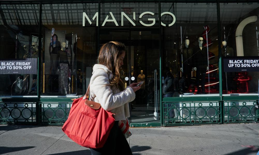 A shopper passes a Mango store on Black Friday in the SoHo neighborhood of New York City.