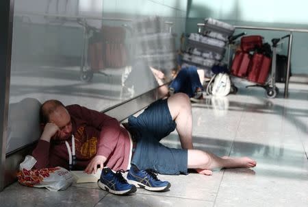 People wait with their luggage at Heathrow Terminal 5 in London, Britain May 27, 2017. REUTERS/Neil Hall