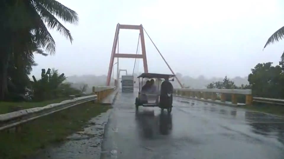 Vehicles battle harsh gusts along a bridge in Cagayan province, Philippines on July 25, 2023. - CNN Philippines