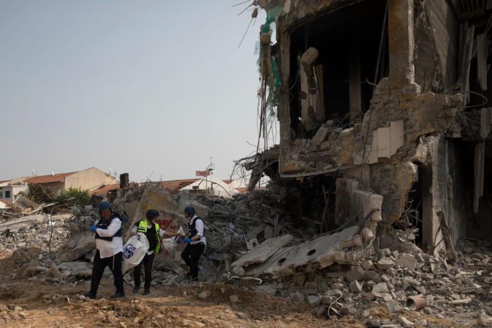 Israeli rescue members work at a police station that was destroyed after a battle between Israeli troops and Hamas militants on October 8, 2023 in Sderot, Israel. On Saturday, the Palestinian militant group Hamas launched the largest surprise attack from Gaza in a generation, sending thousands of missiles and an unknown number of fighters by land, who shot and kidnapped Israelis in communities near the Gaza border. The attack prompted retaliatory strikes on Gaza and a declaration of war by the Israeli prime minister.