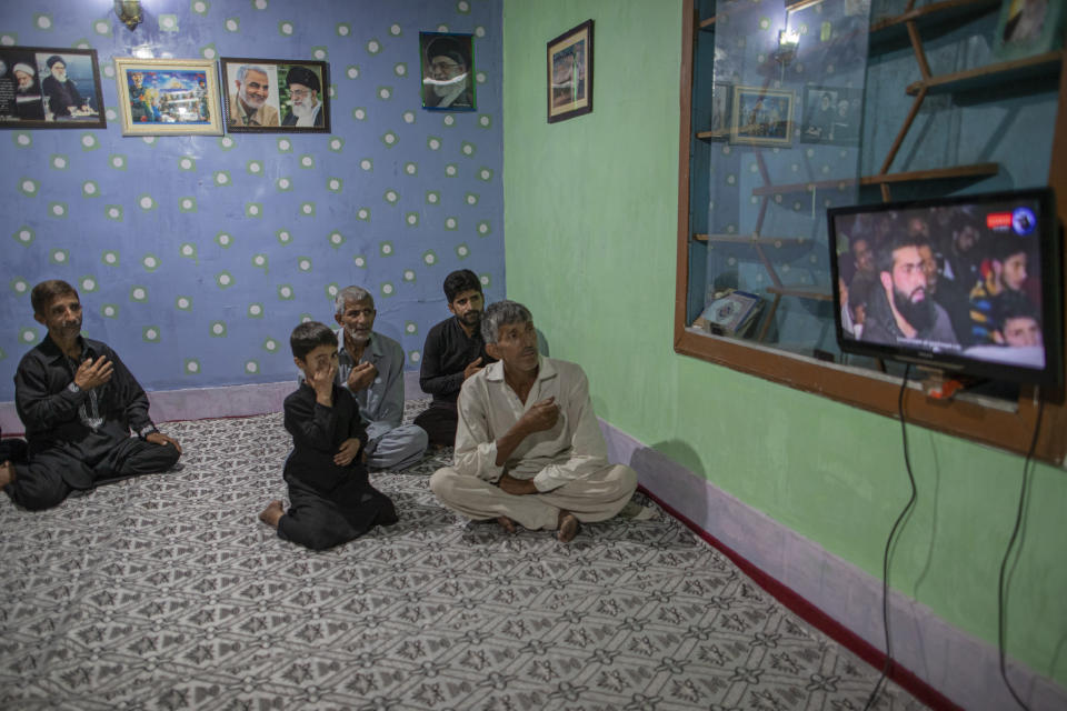 Kashmiri Shiite Muslims beat their chest as they watch religious broadcast on cable television to commemorate Muharram inside their house in the interiors of Dal Lake in Srinagar, Indian controlled Kashmir, Monday, Aug. 24, 2020. Observing the Muslim month of Muharram, which marks the martyrdom of the Prophet Muhammad’s grandson in the battle of Karbala, is an article of faith. But as the coronavirus spreads in Indian-controlled Kashmir, Shiite Muslims prefer to commemorate the holy days inside their home following the advice of religious scholars and health experts in the disputed region’s main city. (AP Photo/Dar Yasin)