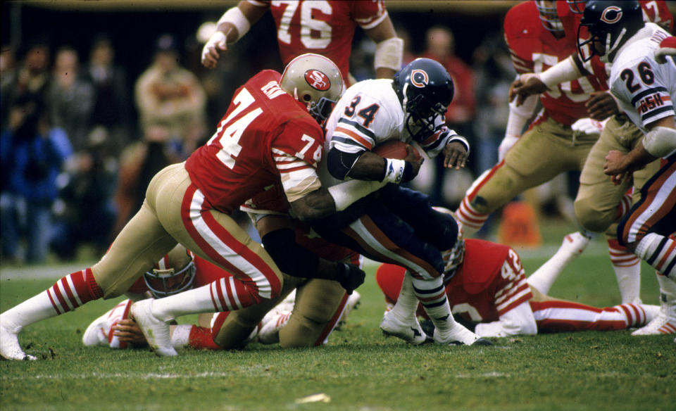 Fred Dean tackles future fellow Hall of Famer Walter Payton in the 1984 NFC Championship Game. (Photo: Rob Brown via Getty Images)