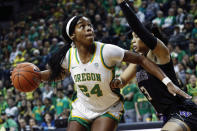 FILE - In this March 1, 2020, file photo, Oregon forward Ruthy Hebard (24) drives to the hoop against Washington forward Mai-Loni Henson (3), during an NCAA college basketball game in Eugene, Ore. Hebard was selected to The Associated Press women's All-America first team, Thursday, March 19, 2020. (AP Photo/Thomas Boyd, File)