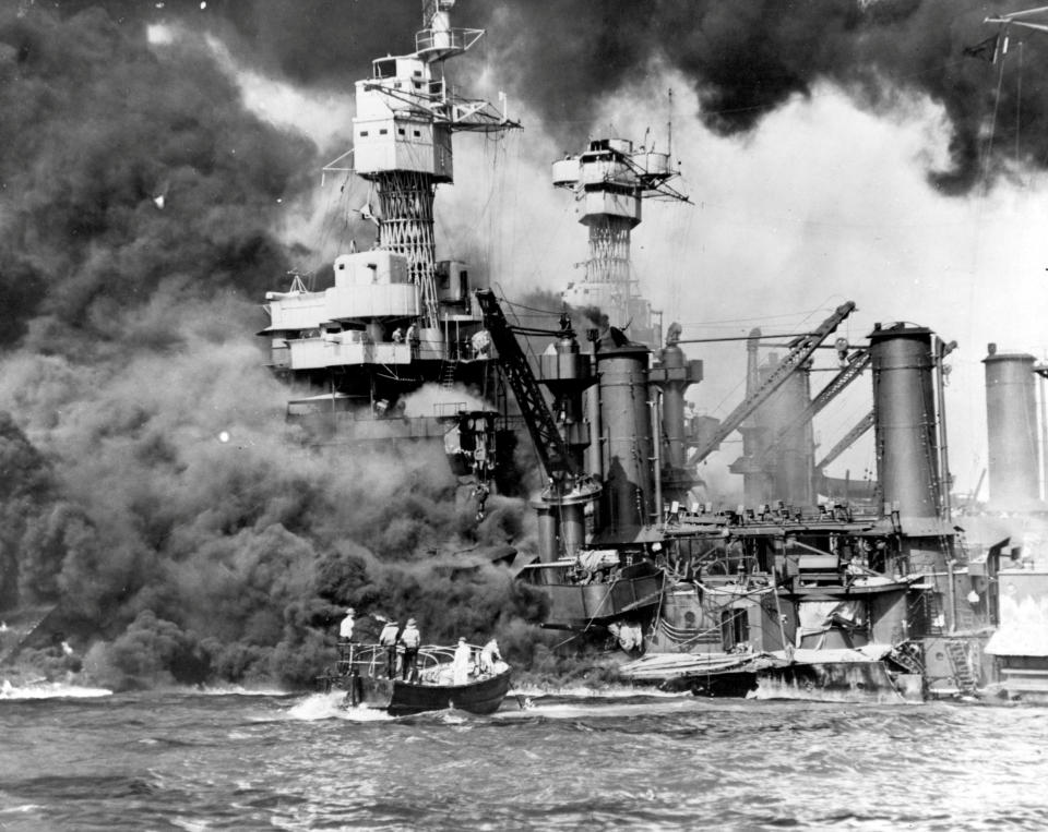 Sailors in a motor launch rescue a survivor from the water alongside the sunken battleship USS West Virginia during or shortly after the Japanese air raid on Pearl Harbor, Hawaii, U.S. December 7, 1941. Picture taken December 7, 1941.  U.S. Navy/National Archives/Handout via Reuters   ATTENTION EDITORS - THIS IMAGE WAS PROVIDED BY A THIRD PARTY. EDITORIAL USE ONLY.