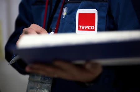 A Tokyo Electric Power Co. (TEPCO) logo is seen on a uniform of an employee at the company's Fukushima Daiichi nuclear power plant in Okuma, Fukushima, Japan, February 23, 2017. REUTERS/Tomohiro Ohsumi/Pool/Files