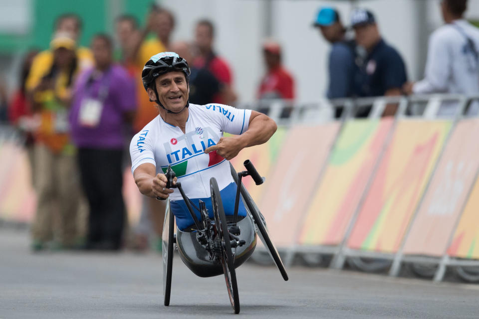 Italy's Alessandro Zanardi celebrates after winning gold medal at the men's team relay H2-5 road cycling event at the Rio 2016 Paralympic games at Pontal beach in Rio de Janeiro, Brazil, Sept. 16, 2016. (AP Photo/Mauro Pimentel)