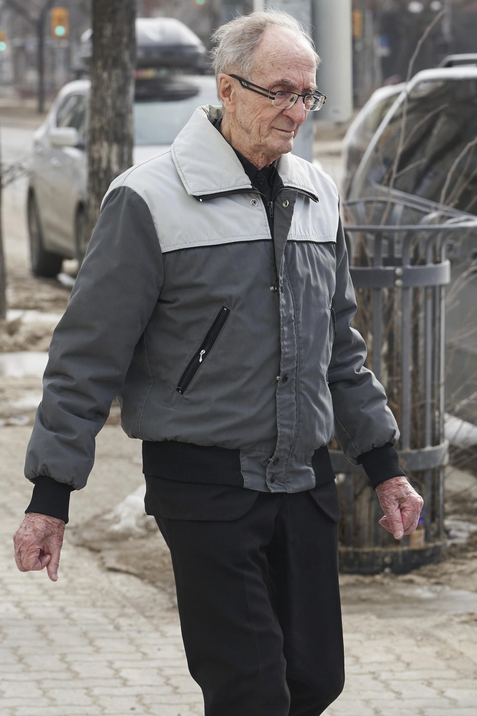 Retired priest Arthur Masse, 93, leaves the Law Courts in Winnipeg, Thursday, March 30, 2023 after a judge acquitted him of forcing himself on a residential school student more than 50 years ago, saying she believes an assault happened but could not determine beyond a reasonable doubt who did it. (David Lipnowski /The Canadian Press via AP)