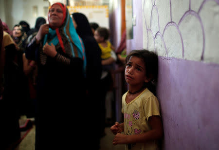 Relatives of a Palestinian, who was killed at the Israel-Gaza border, mourn during his funeral in Gaza City June 18, 2018. REUTERS/Mohammed Salem