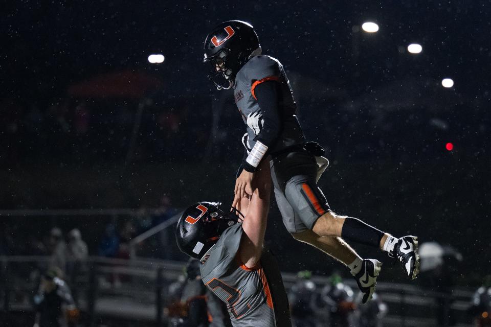 Uxbridge's Nathan Noyes lifts Kellen LaChapelle after LaChapelle scored in the first quarter against South High.