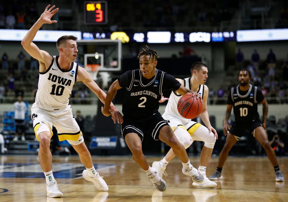 Chance McMillian of Grand Canyon drives the ball against Joe Wieskamp of Iowa during the first half in the first round game of the 2021 NCAA Men's Basketball Tournament at Indiana Farmers Coliseum on March 20, 2021 in Indianapolis, Indiana.