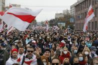 People with old Belarusian national flags march during an opposition rally to protest the official presidential election results in Minsk, Belarus, Sunday, Oct. 25, 2020. The demonstrations were triggered by official results giving President Alexander Lukashenko 80% of the vote in the Aug. 9 election that the opposition insists was rigged. Lukashenko, who has ruled Belarus with an iron fist since 1994, has accused the United States and its allies of fomenting unrest in the ex-Soviet country. (AP Photo)