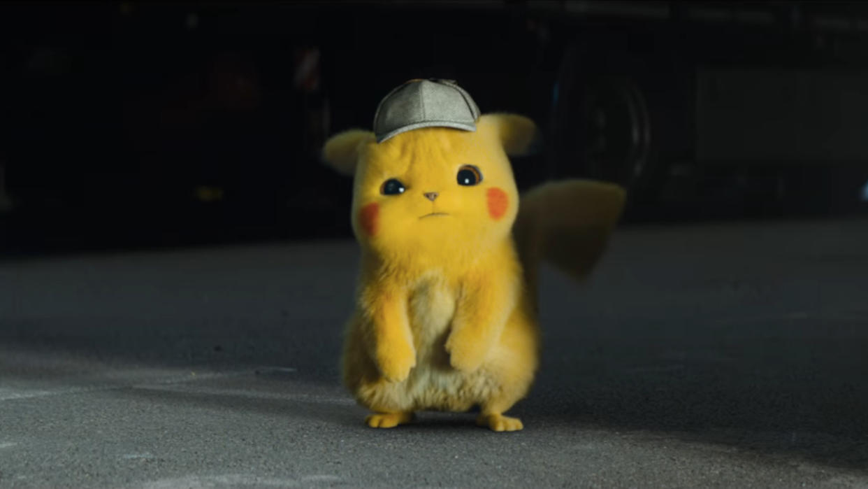  Detective PIkachu looks puzzled while standing near a warehouse in Pokémon Detective Pikachu. 