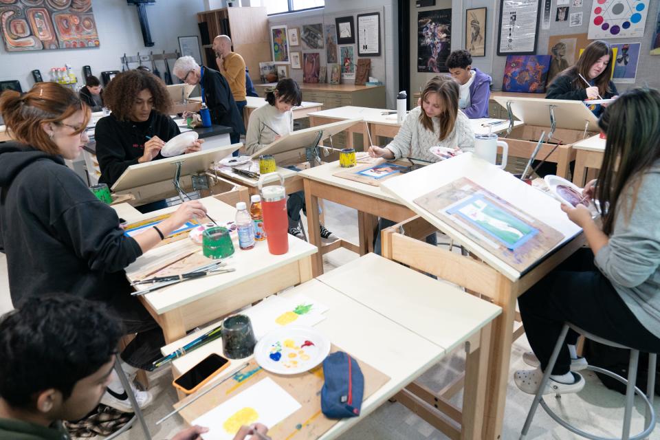 Washburn Rural High School painting students inside Brad LeDuc's classroom use kids of paint brushes once owned by artist Denise Evans Friday morning.