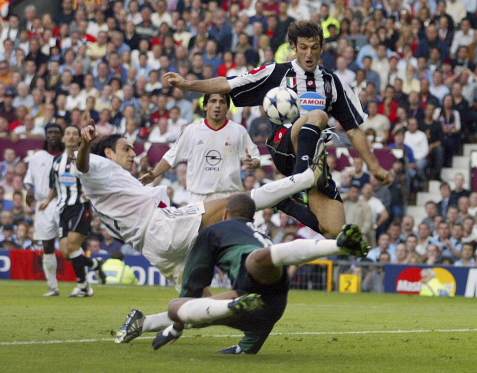 FILE - In this Wednesday May 28, 2003 file photo Juventus' Ciro Ferara, right, is challenged by AC Milan's Alessandro Nesta, left, and goalkeeper Dida, of Brazil, during the UEFA Champions League final between Juventus and AC Milan at Old Trafford, Manchester, England. W is for Worst. There have been many disappointing finals, but this ultra-dour and defensive 0-0 draw, despite the attacking talents of Shevchenko and Del Piero on display, that was decided on penalties is often labelled the worst final of all time. (AP Photo/Thomas Kienzle)