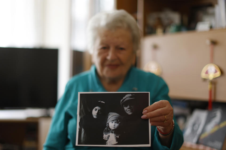 Holocaust survivor Assia Gorban, shows a Picture of her family during an interview with The Associated Press in Berlin, Germany, Monday, April 3, 2023. Over 100 Holocaust survivors and their descendants are participating in a new social media campaign that illustrates the importance of passing on the Holocaust survivors’ testimonies as their numbers dwindle. (AP Photo/Michele Tantussi)