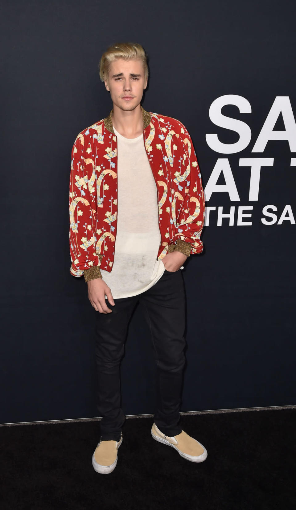 Justin Bieber, as cool as ever, in a Saint Laurent’s red bomber jacket and black jeans. 